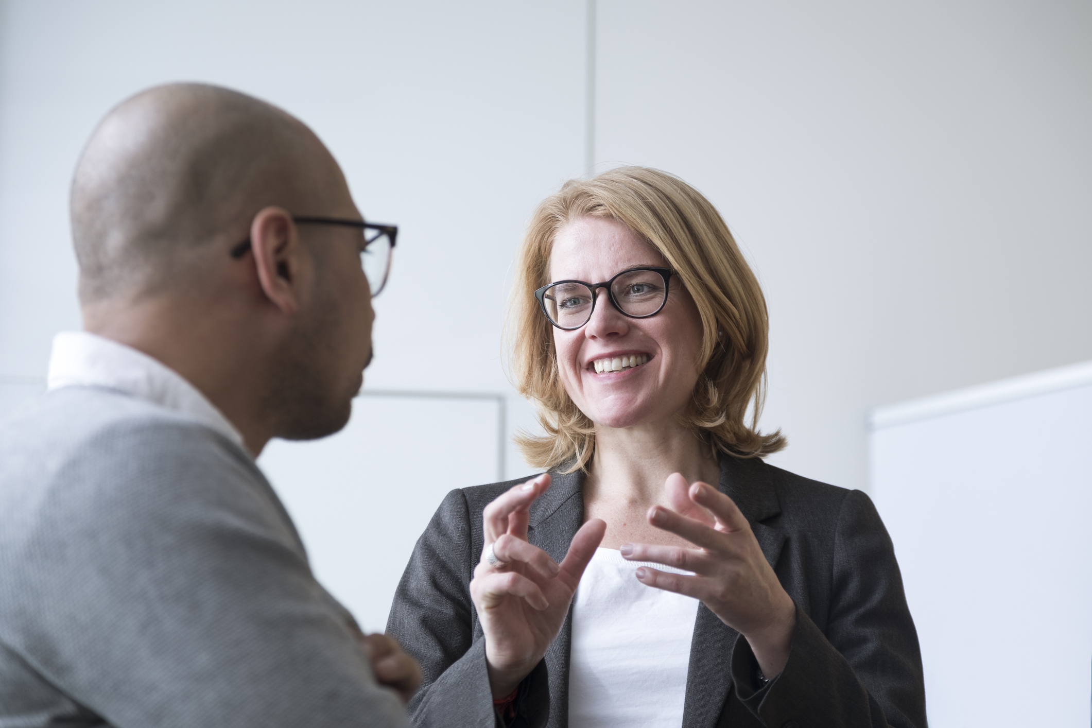 Photo of a man and woman talking to each other and looking for solutions.