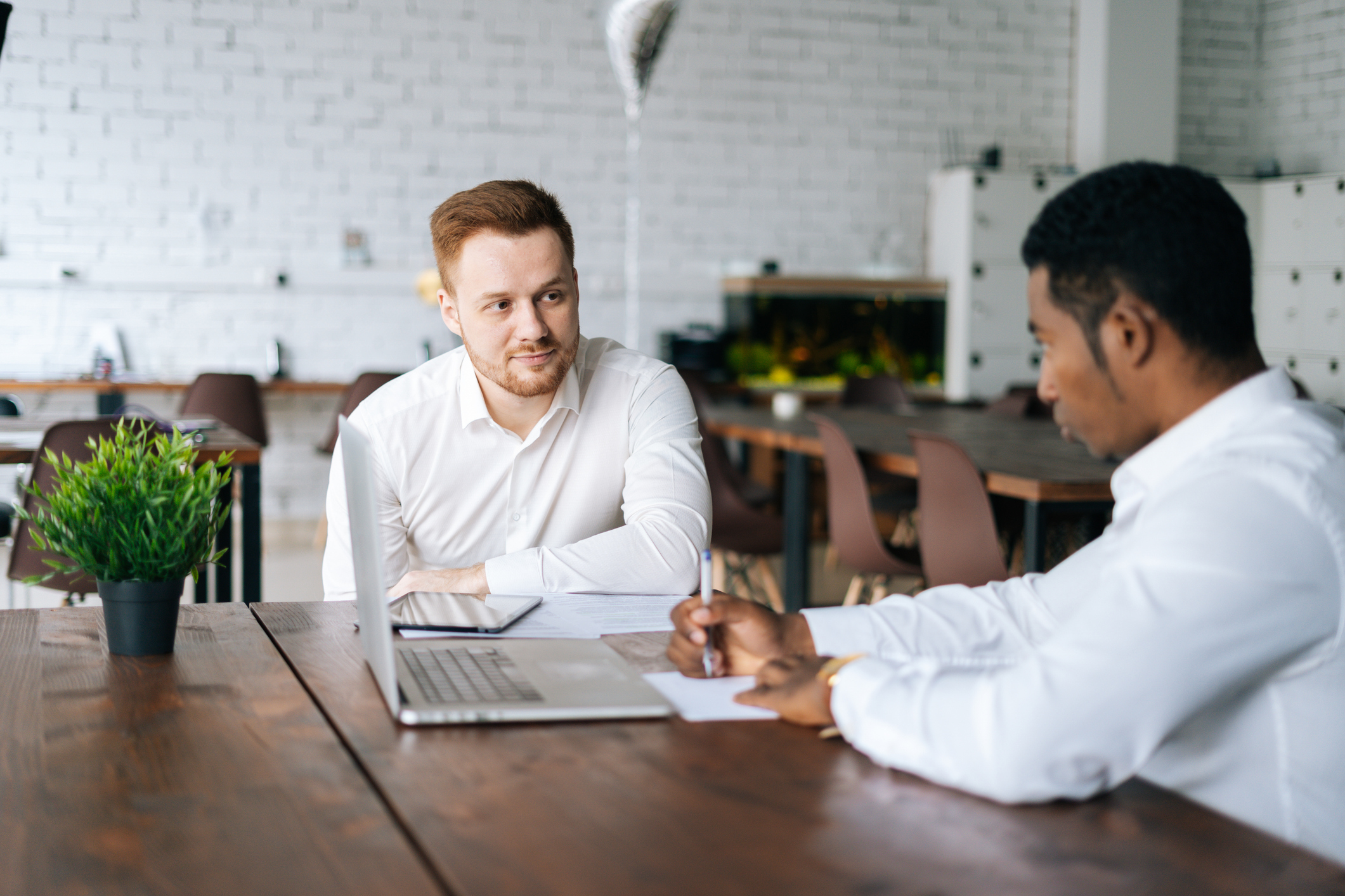 Photo of a business meeting with two males at an office