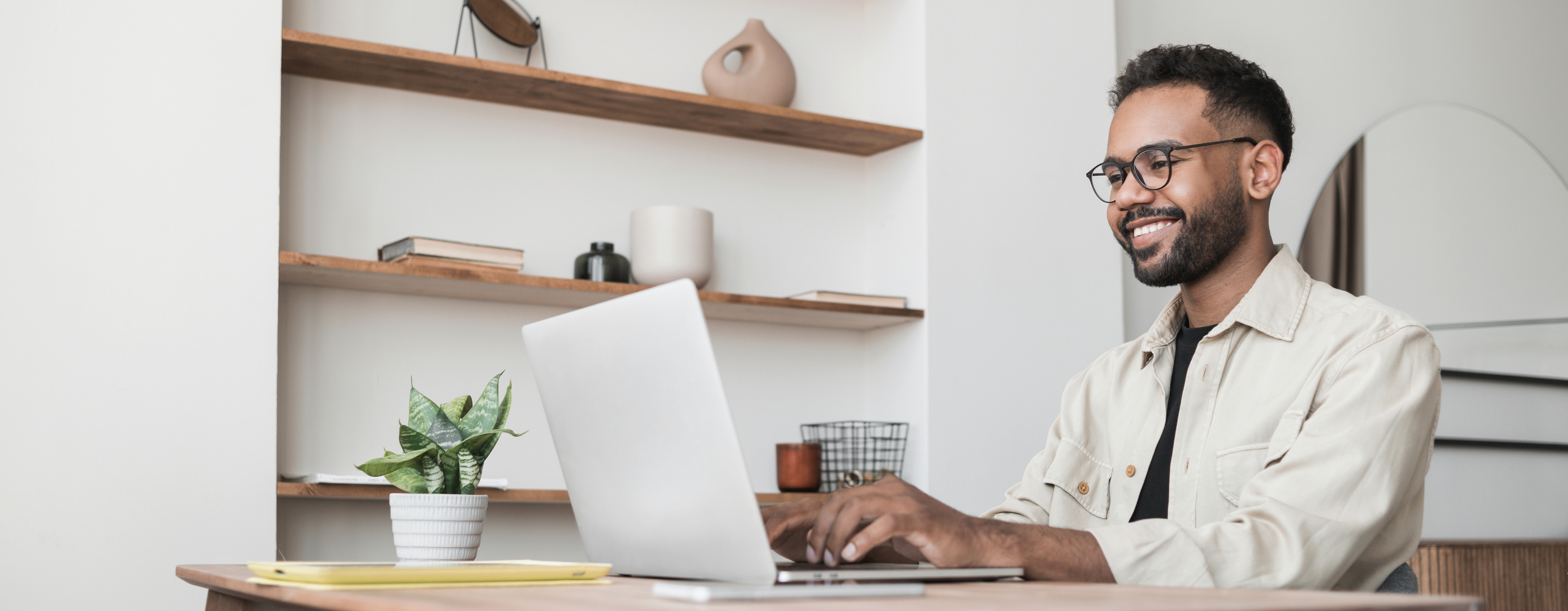 Photo of a man using laptop working at home.