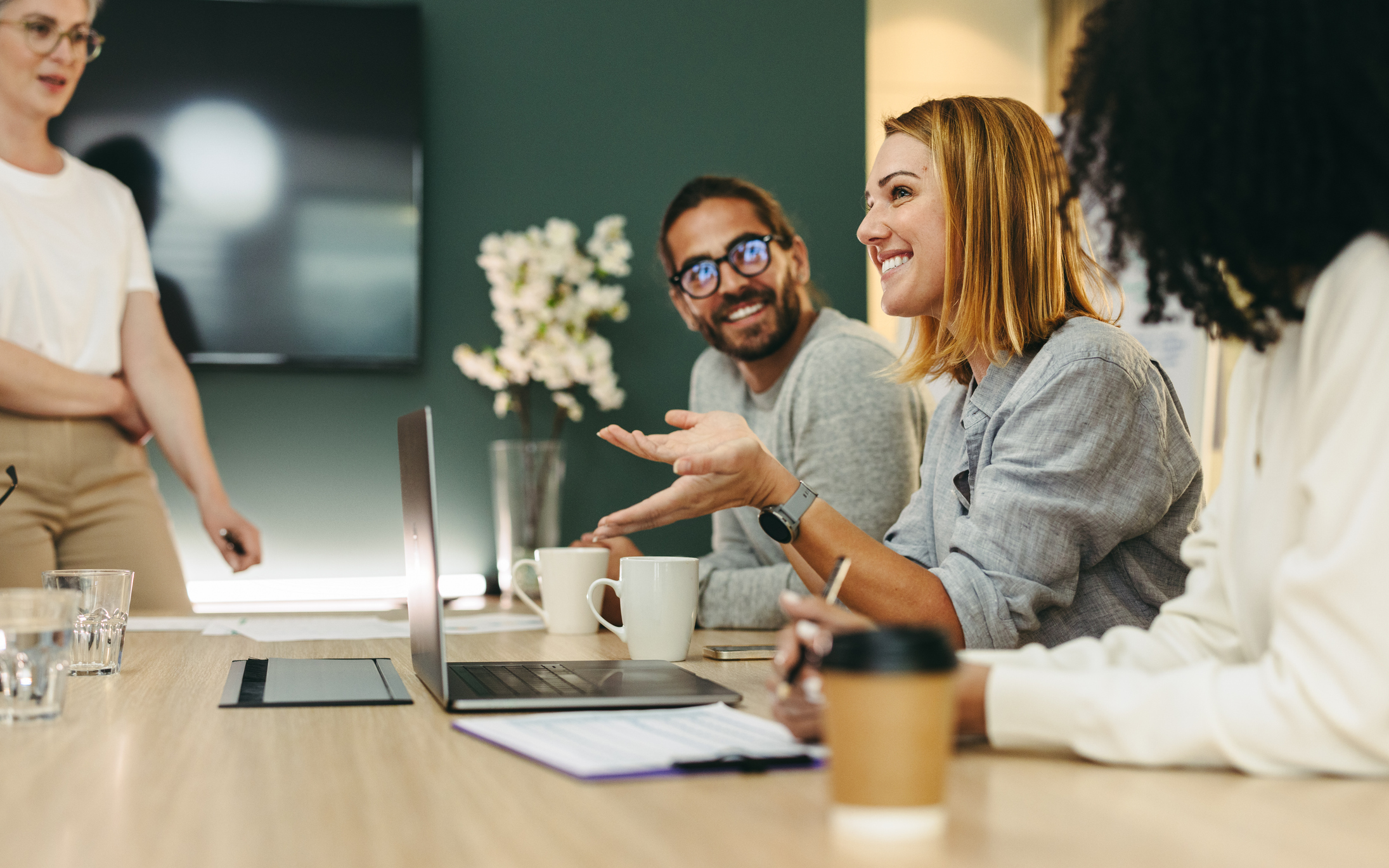 Photo of a group of happy business people working together in a creative office.