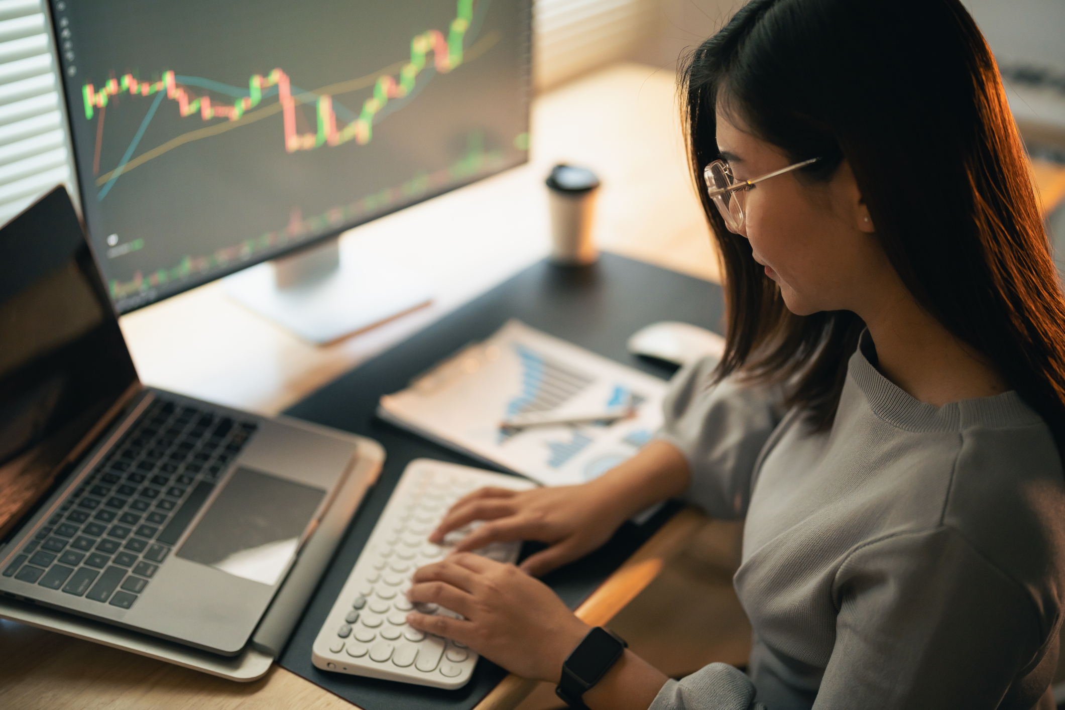 Photo of a woman at a computer working