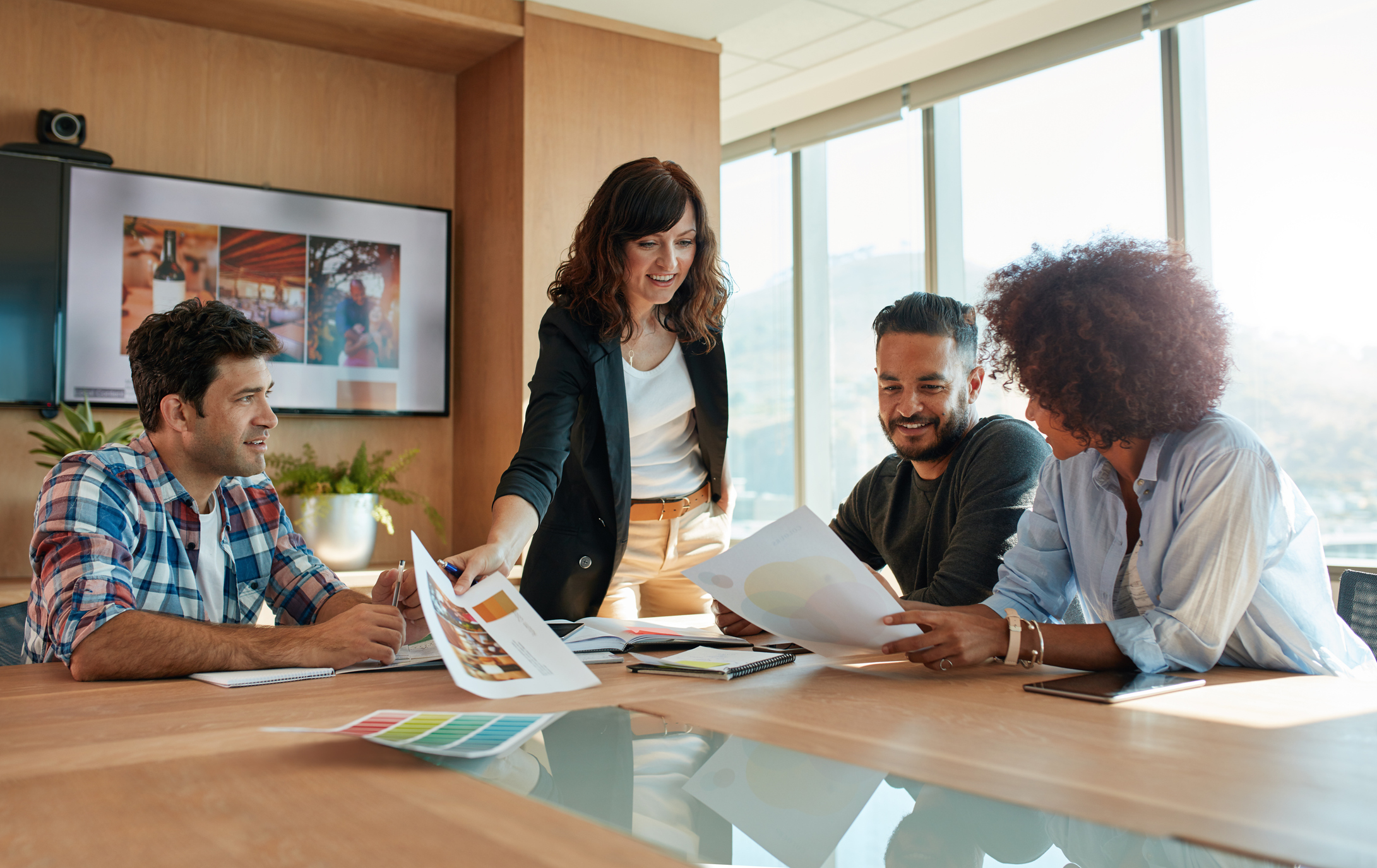 Photo of a group of young business people meeting in conference room.