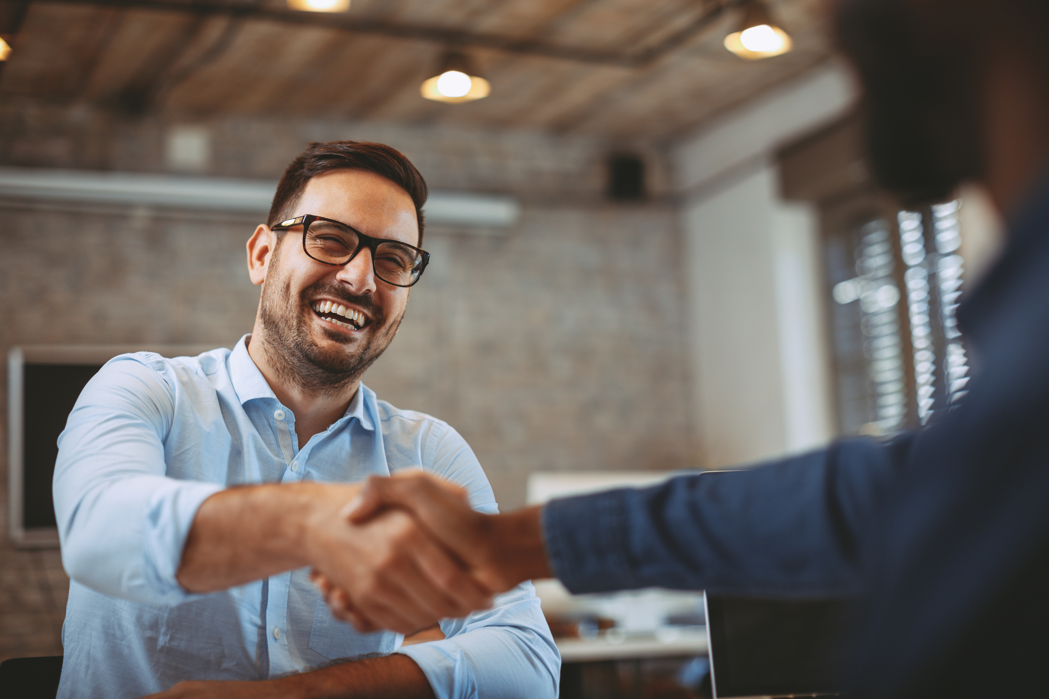 Close up photo of handshake in the office