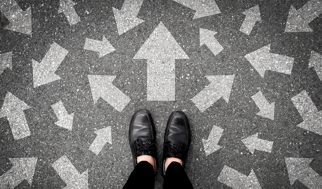 Image of a feet standing on ground with arrows going in many different directions